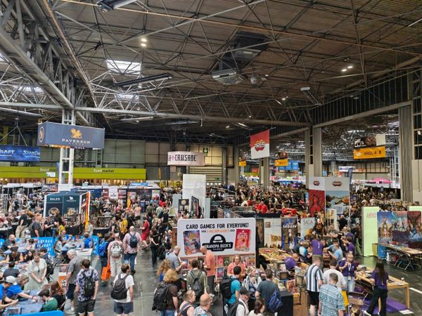 A photo from the UK Games Expo held at the NEC in Birmingham. There are hundreds of people in shot, looking at various stands