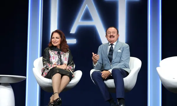 Two guests take part in an on-stage conversation beneath L'ATTITUDE signage at the 2024 conference in San Diego.