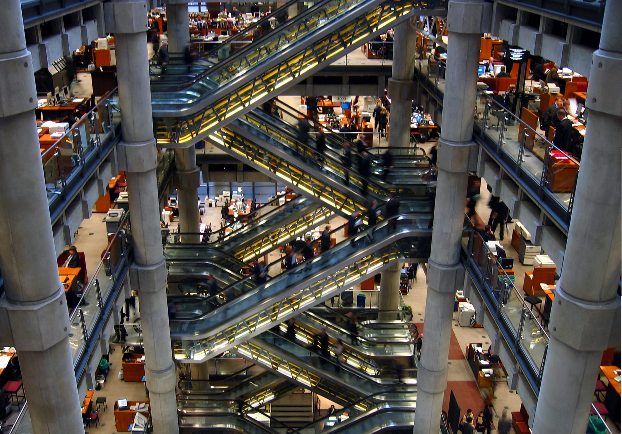 The interior underwriting room of the Lloyd’s building, with crisscrossing escalators