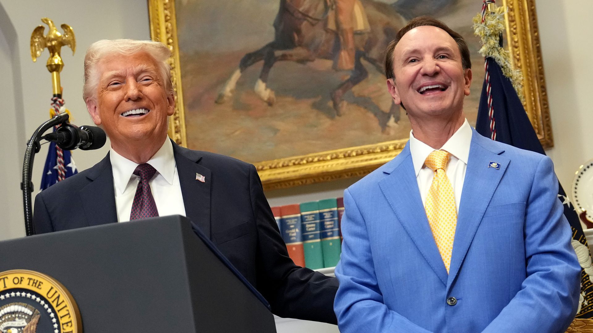 Donald Trump stands beside Louisiana Governor Jeff Landry during a public event.