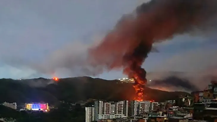 Thick smoke rises over Caracas skyline following reported U.S. strikes in Venezuela