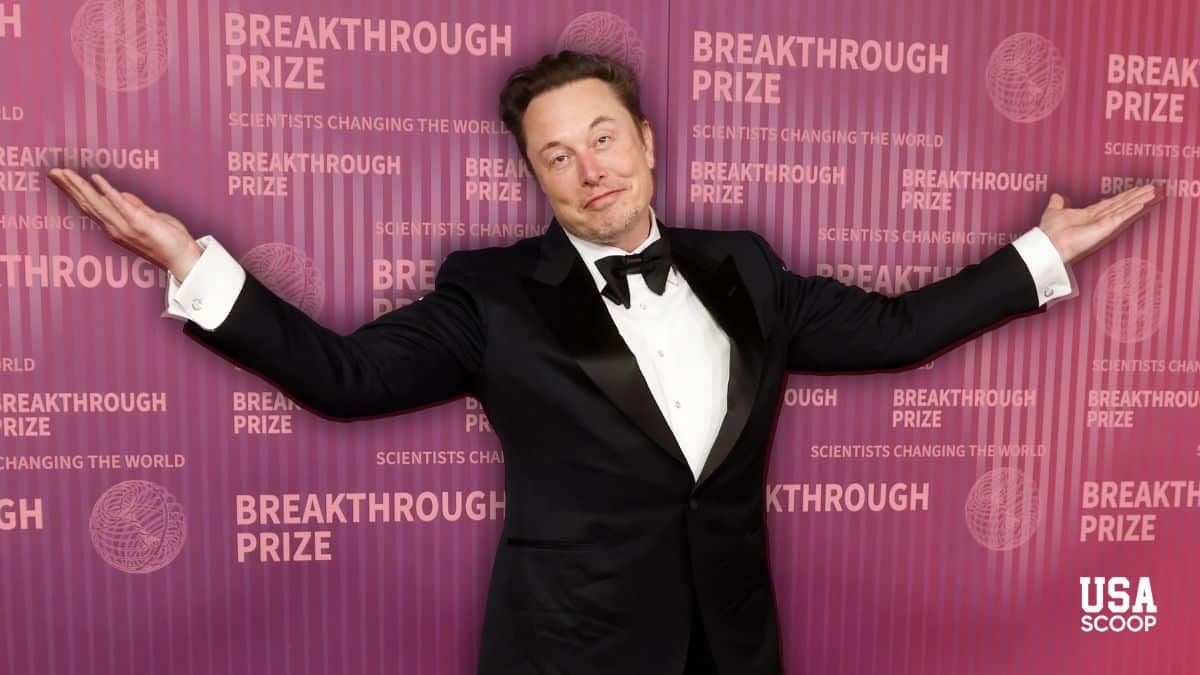 Elon Musk posing with arms out at a red carpet event as investors predict his $1 trillion Tesla pay deal will pass