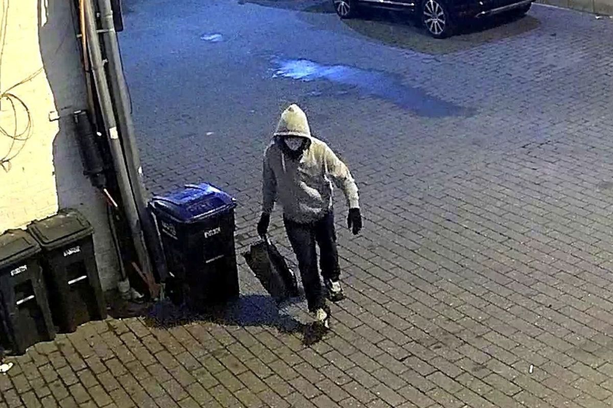 Surveillance image of a hooded suspect carrying a bag in Washington, D.C., before Jan. 6.