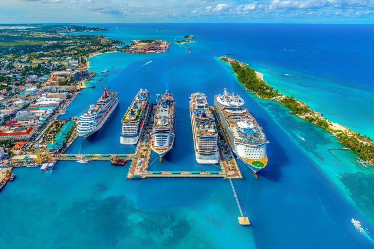 Multiple cruise ships docked at a Caribbean port