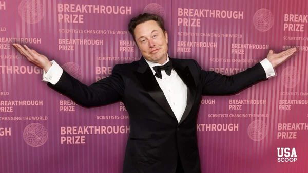 Elon Musk posing with arms out at a red carpet event as investors predict his $1 trillion Tesla pay deal will pass