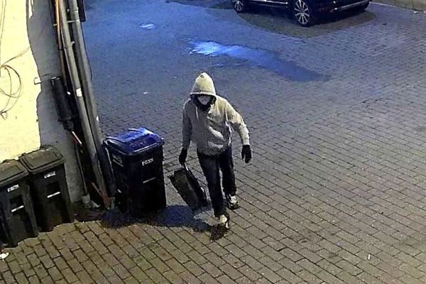 Surveillance image of a hooded suspect carrying a bag in Washington, D.C., before Jan. 6.