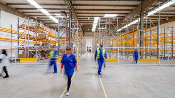 Long empty aisle between tall warehouse racking