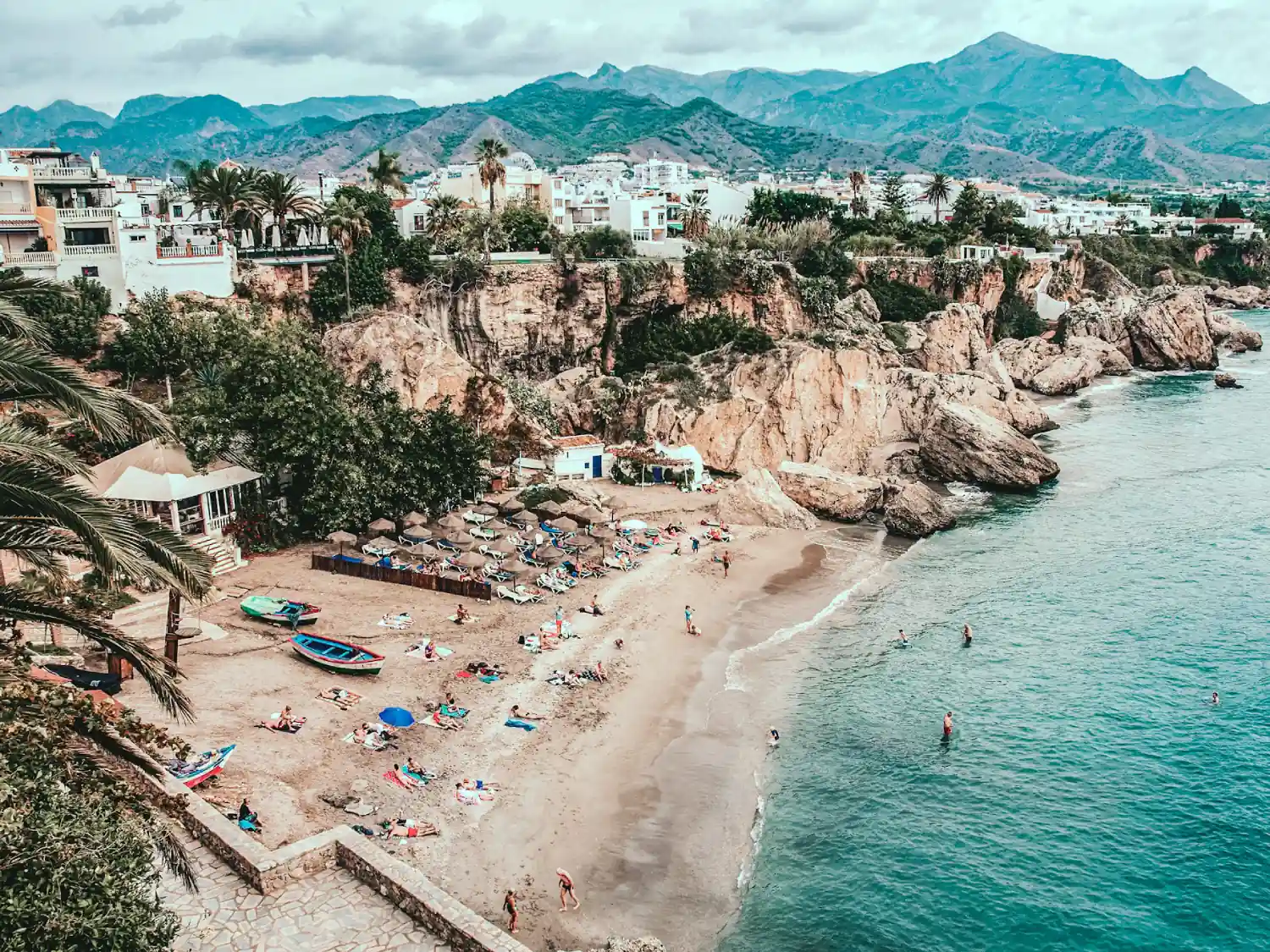 Beach in Nerja, Costa Del Sol with mountains in the background.