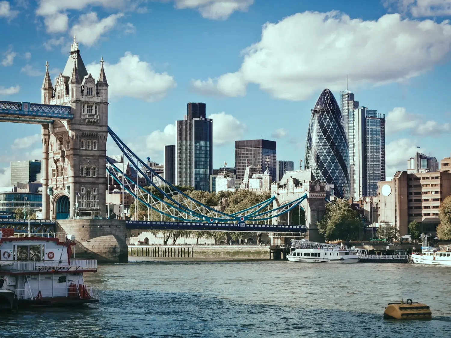 View over the River Thames, Tower Bridge, and the Financial district of London, England.
