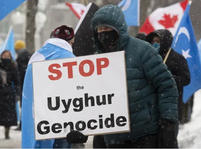 Protestor in Canada Against The Uyghur Genocide in China Holding Sign