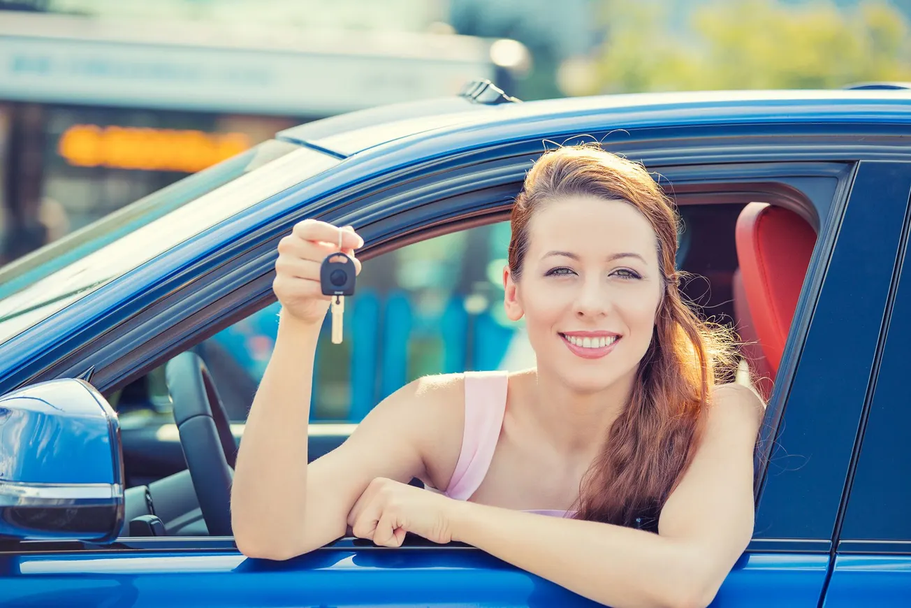 Lady holding car keys outside of car