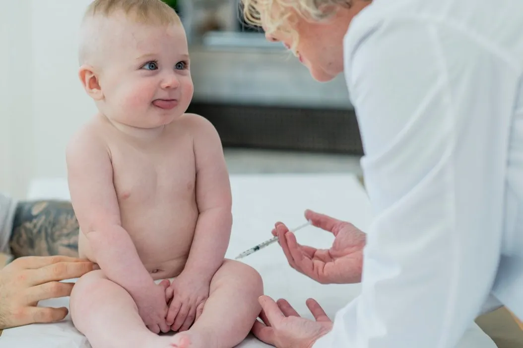 Baby being injected by a vaccine