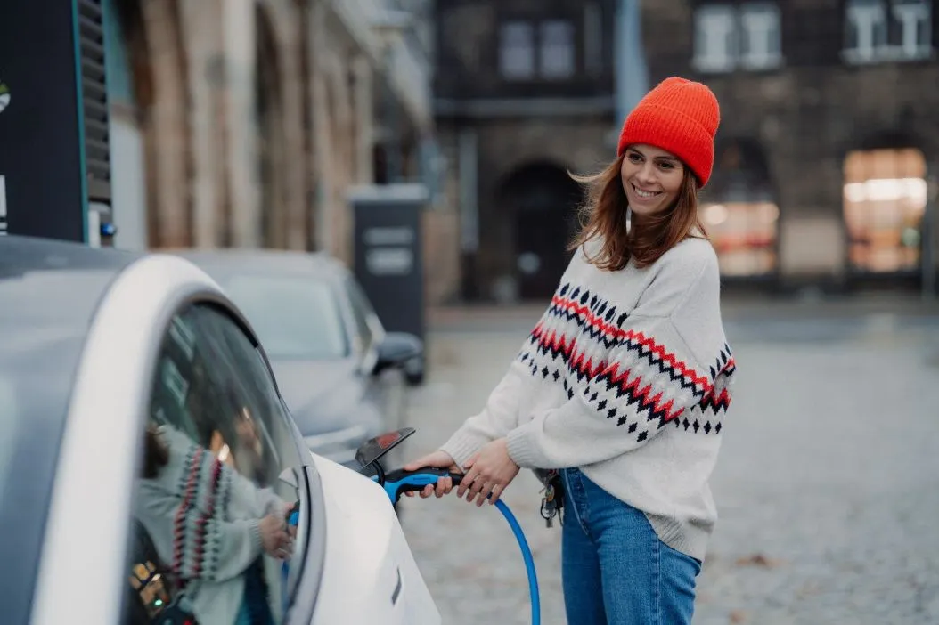 Lady charging her electric car