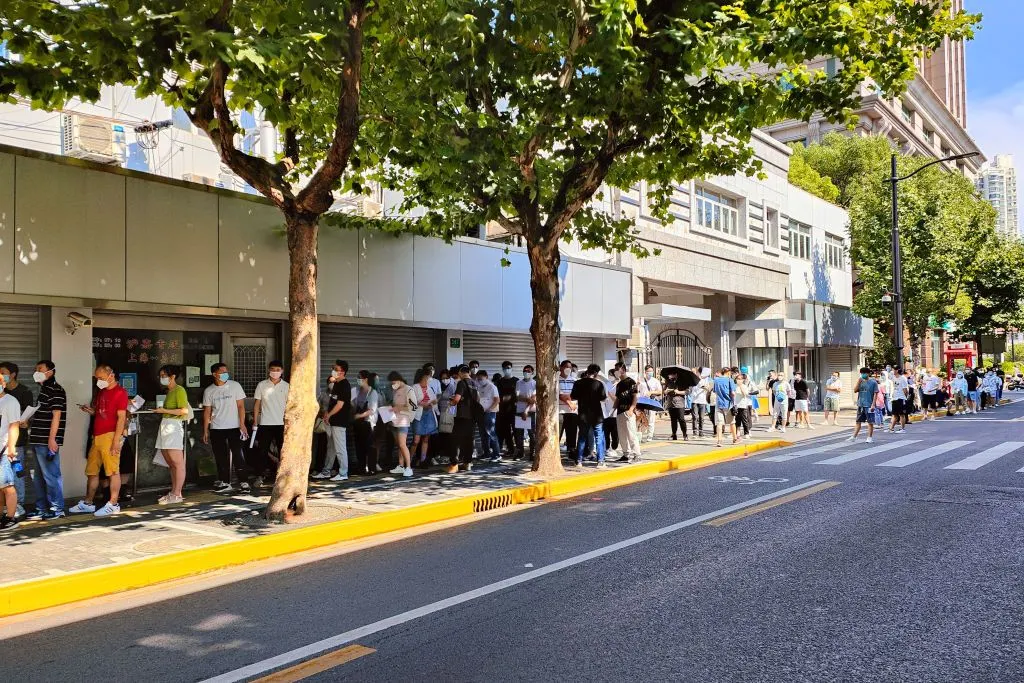 Job seekers queue nearly 100 meters outside a registration office for physical examination in Shanghai