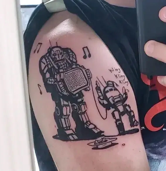 Picture of my Battletech tattoo. The larger mech is playing music and the smaller one is dancing.