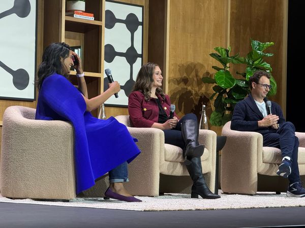 A photo from a session titled "A conversation with Dario Amodei and Daniela Amodei" on the main stage. stage of the Code with Claude 2026 conference in San Francisco..
