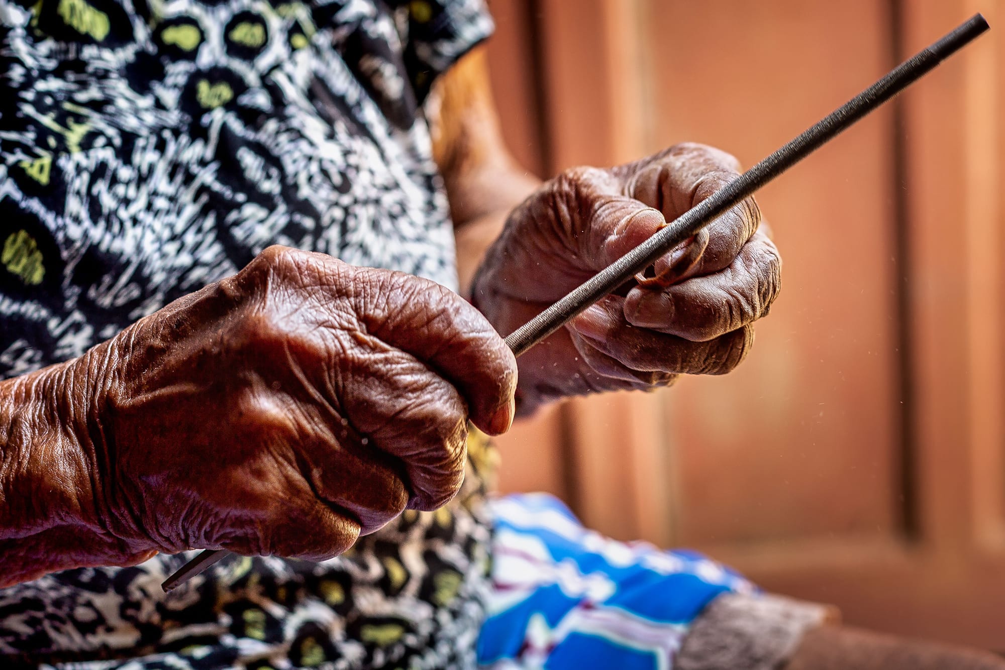 Shot of Odete Kuruaya's hands holding a short stick