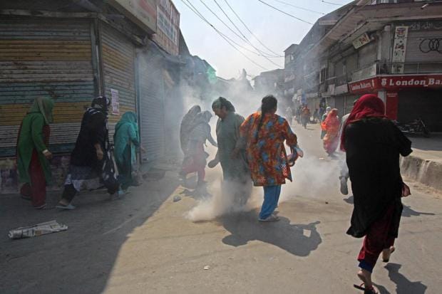 A women's protest about braid chopping in Kashmir, India, is dispersed by police using tear gas. October 2017. Image Faisal Khan_Zuma Press_PA Images.jpg