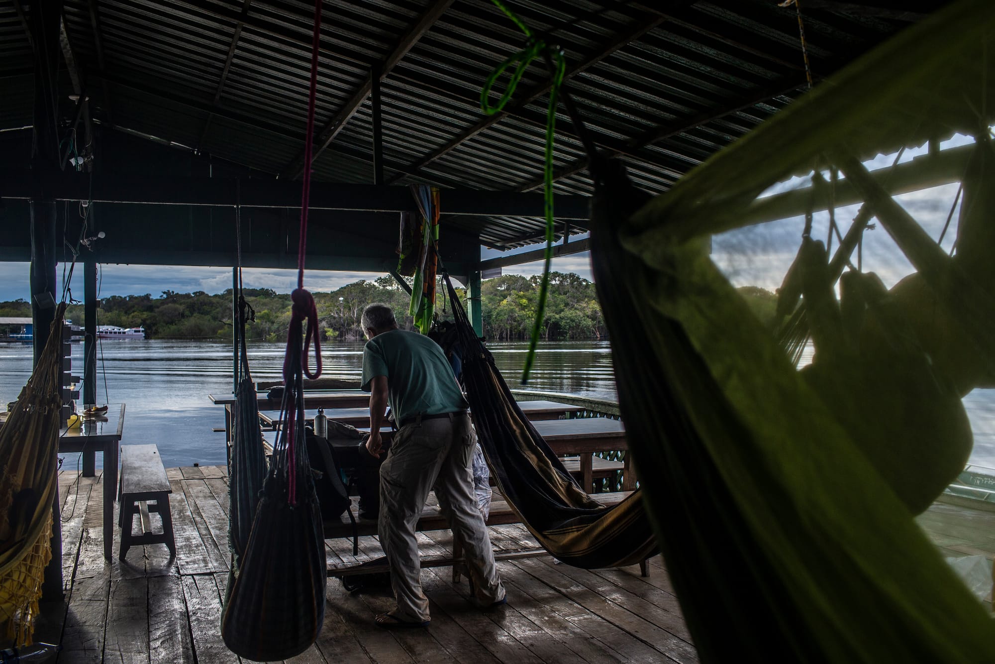 El científico Carlo Cohn-Haft organiza la mesa de trabajo en el restaurante flotante alquilado por los investigadores para su trabajo con las olondrinas azules