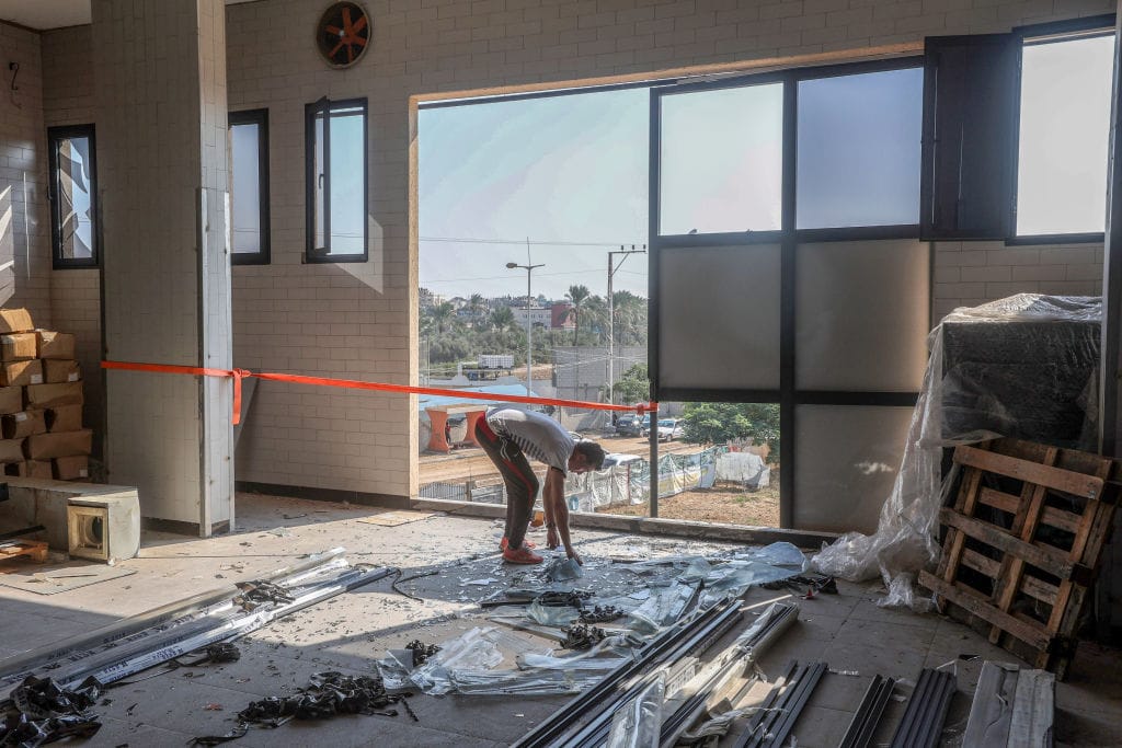 Homem curvado em prédio em construção