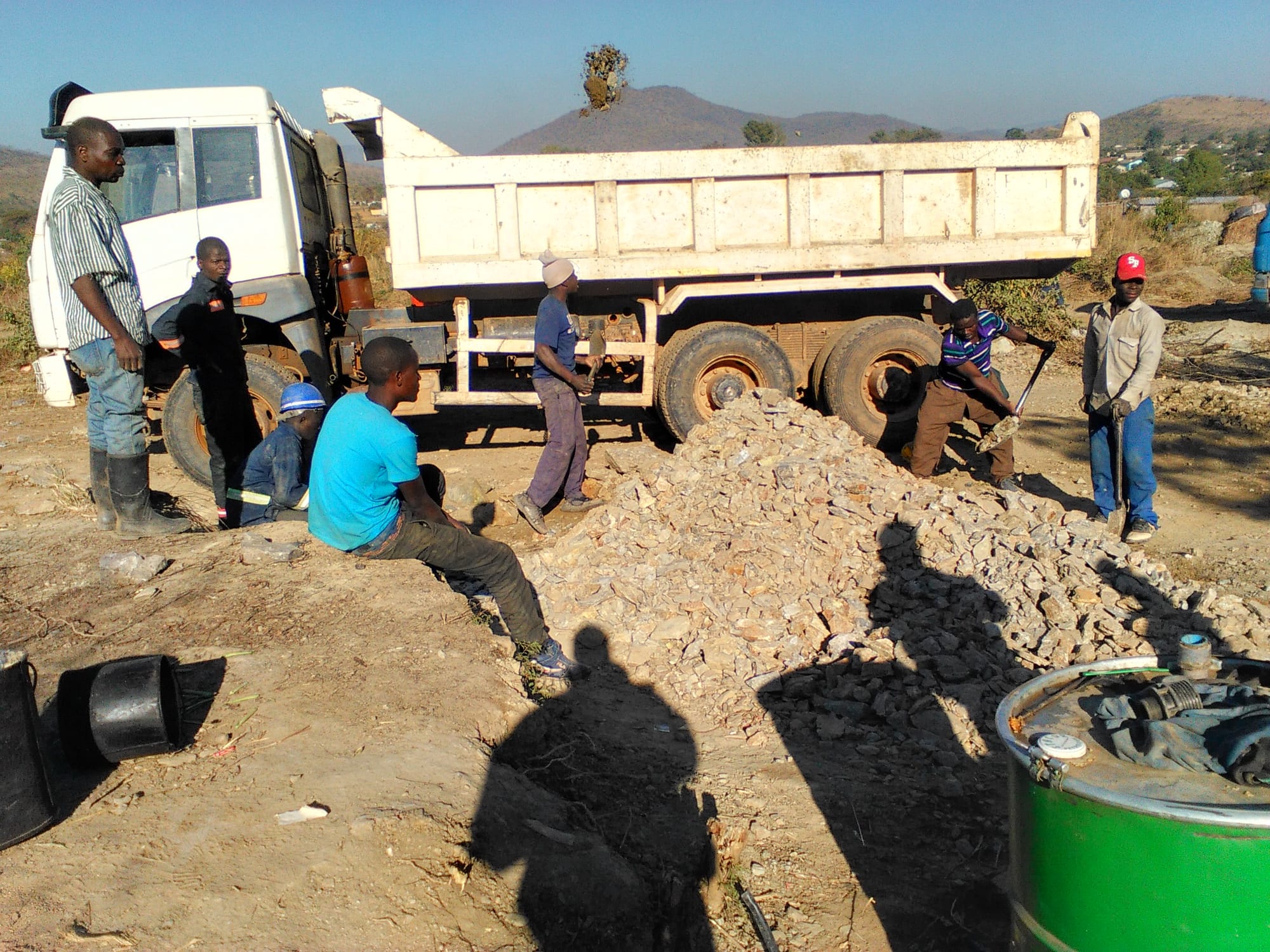 Men and boys load ore into truck.jpg