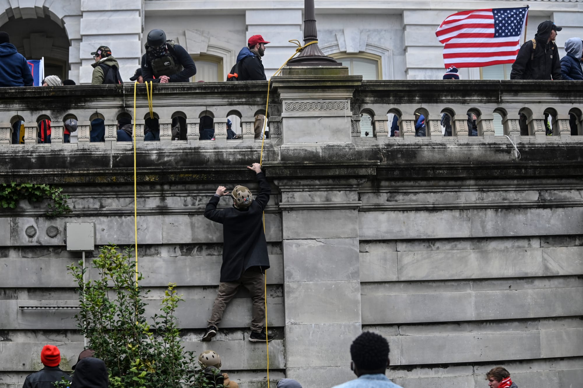 A Donald Trump supporter climbs the walls of the United States Capitol during the Trump inspired insurgency.