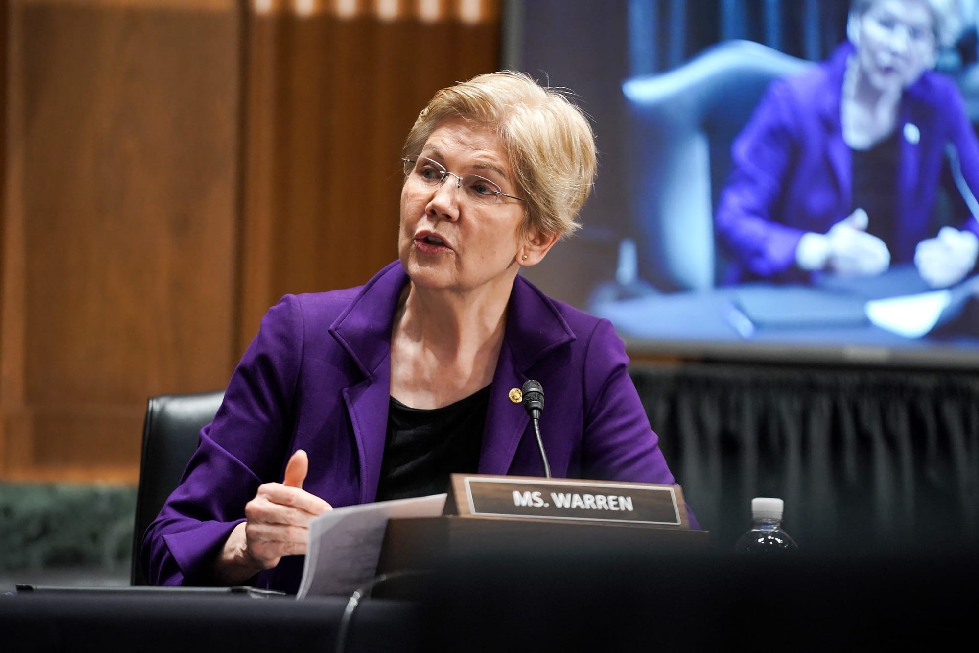 A senadora Elizabeth Warren fala vestindo um blazer roxo.