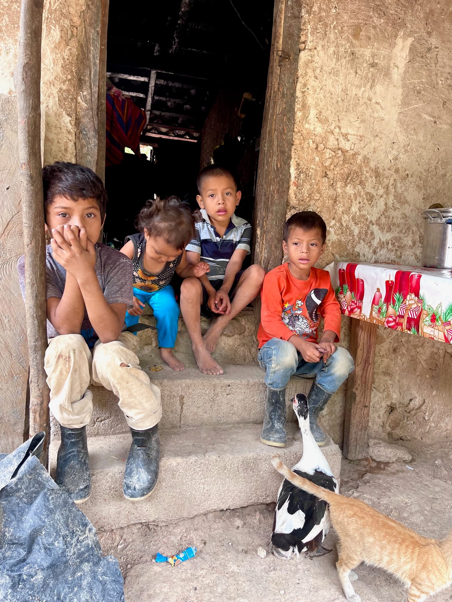 The Mejía family children in the doorway of their home