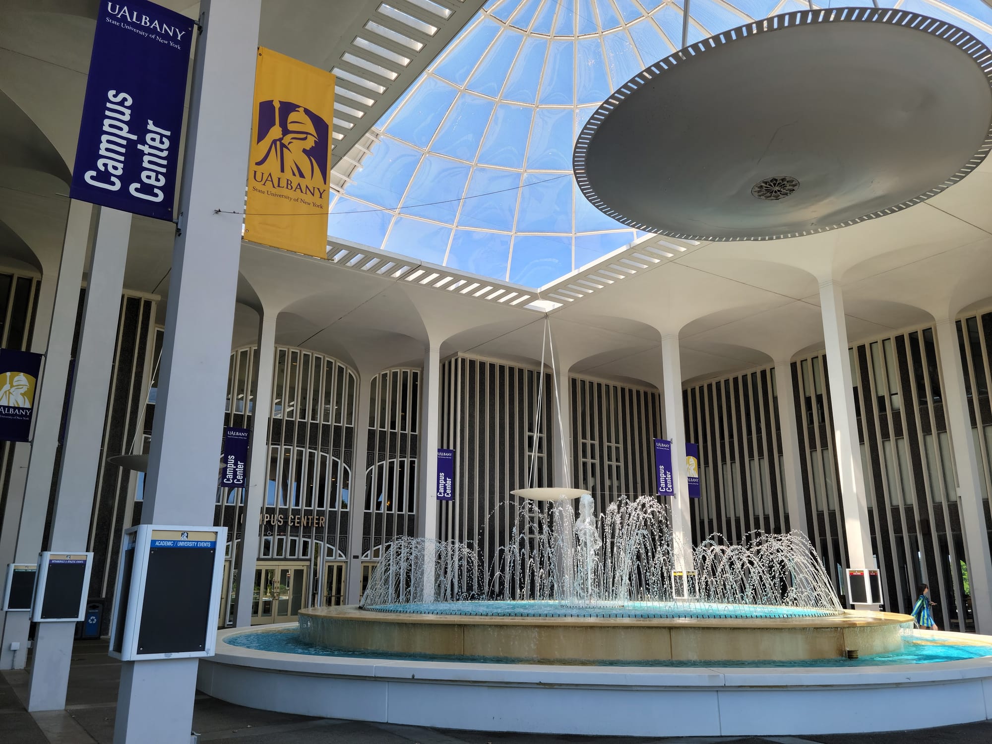 A photo of an outdoor, canopied fountain outside the Campus Center of UAlbany