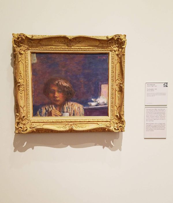 A photograph of the painting "The Breakfast" by Pierre Bonnard as it hangs in the High Museum of Atlanta, Georgia.