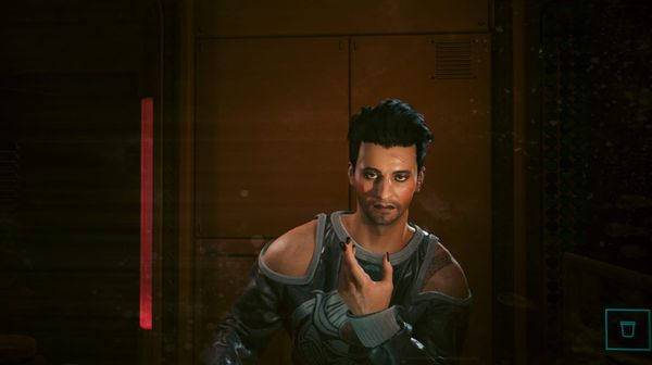 A screenshot from the game Cyberpunk 2077 showing the author's player character, a young white man, looking in the mirror.