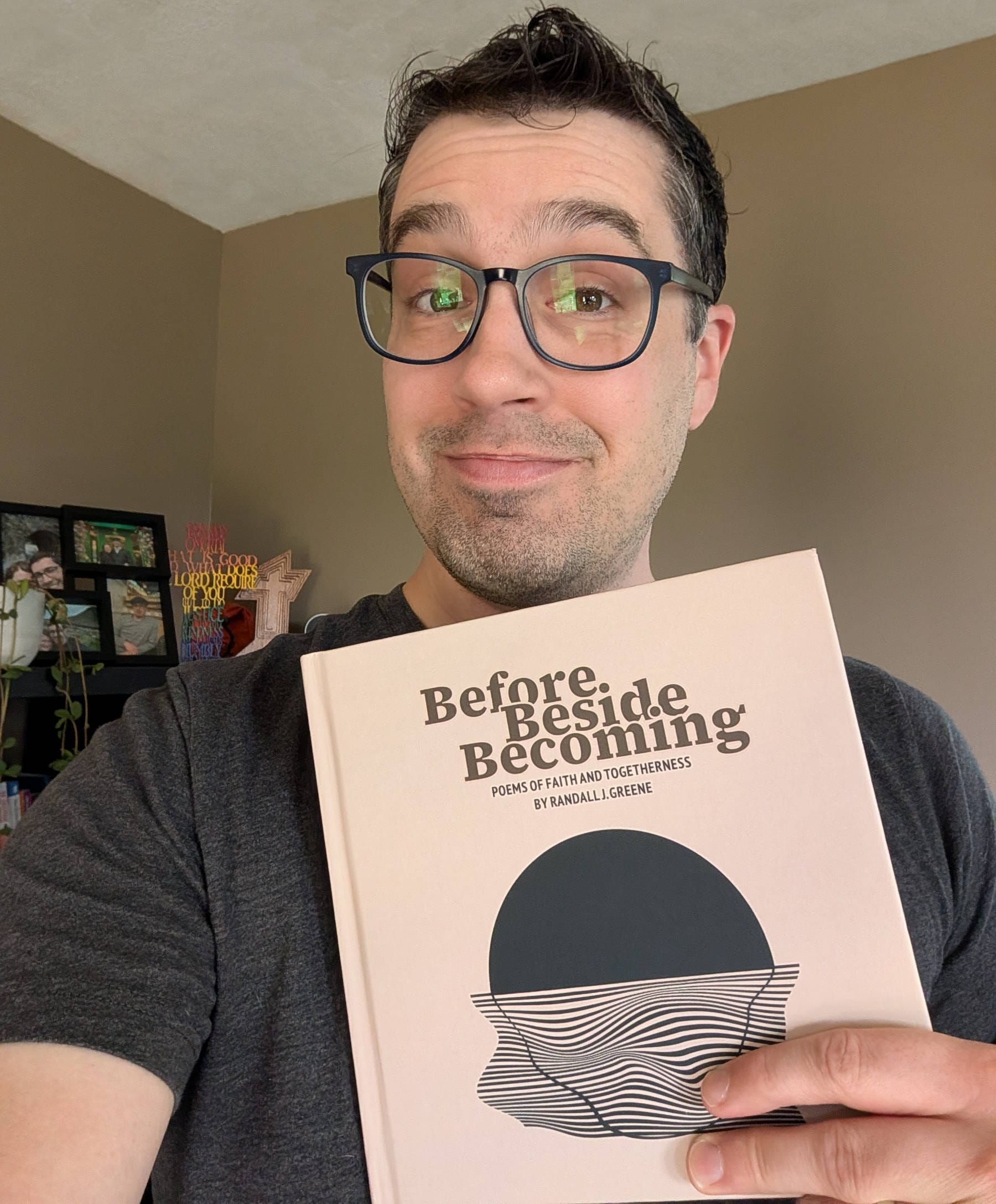 Me holding a copy of "Before Beside Becoming: Poems of Faith and Togetherness."