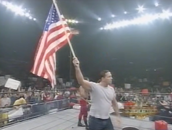 Bret "Hitman" Hart, noted disliker of the United States of America, hoists said country's flag high.
