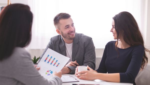 Young professional cheering at investment growth results and wealth management progress.