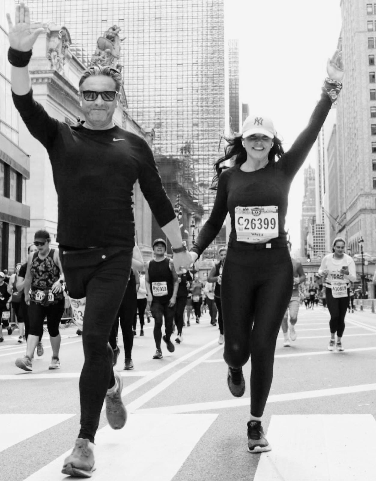 Christoph and Rachel running hand in hand through New York, both raising an arm