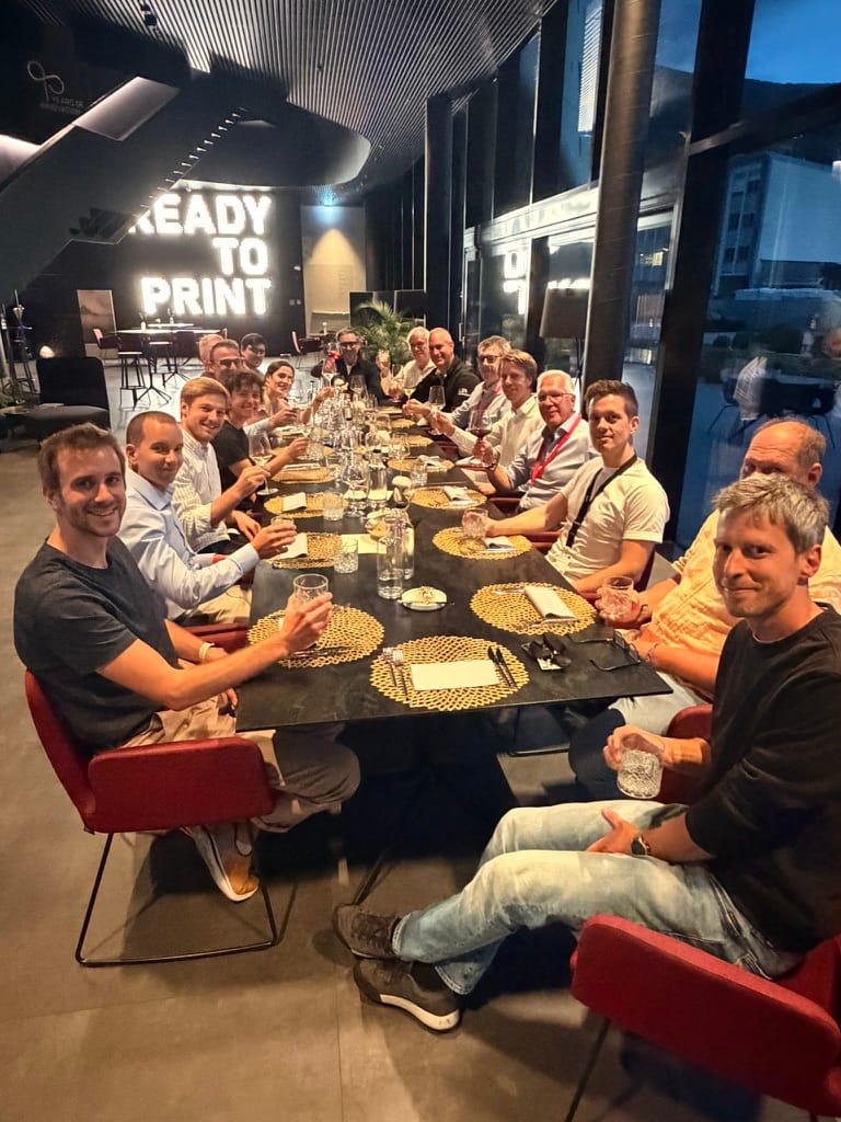 The Kyveris team at a long dinner table in Brixen after the architecture workshop.