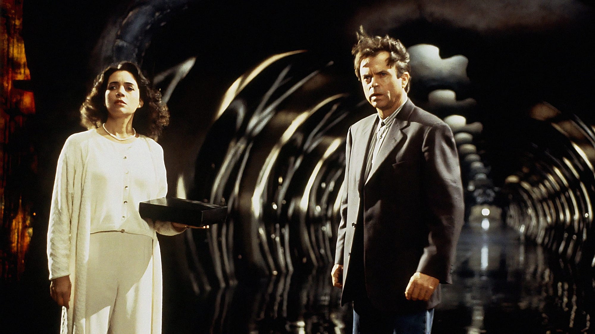 Julie Carmen and Sam Neill in In the Mouth of Madness