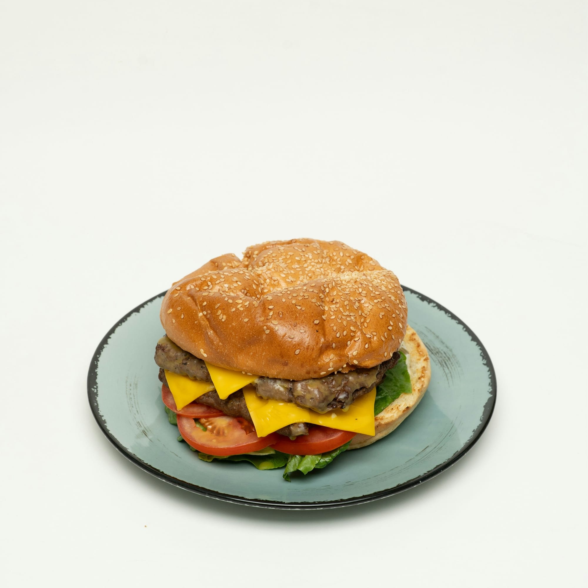 A cheeseburger plated and photographed close up from the front