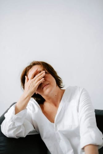 Woman looking stressed while researching online business opportunities