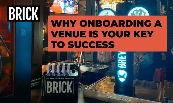A 6 slot Brick power bank sharing station placed prominently on a bar