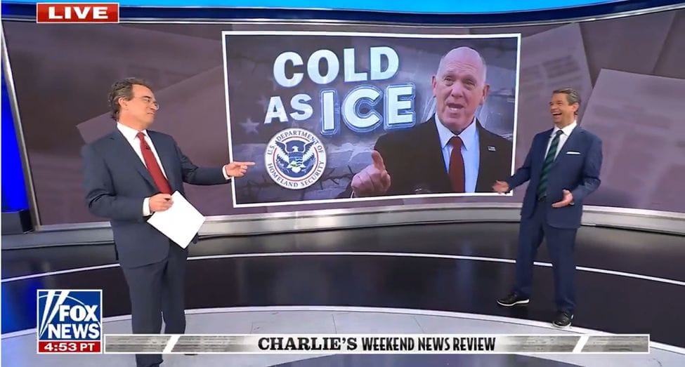 Two male FOX News anchors stand on a modern news bluescreen space. Projected on the background is a photograph of chief border fascist Tom Homan and the legend COLD AS ICE. The two men are laughing.