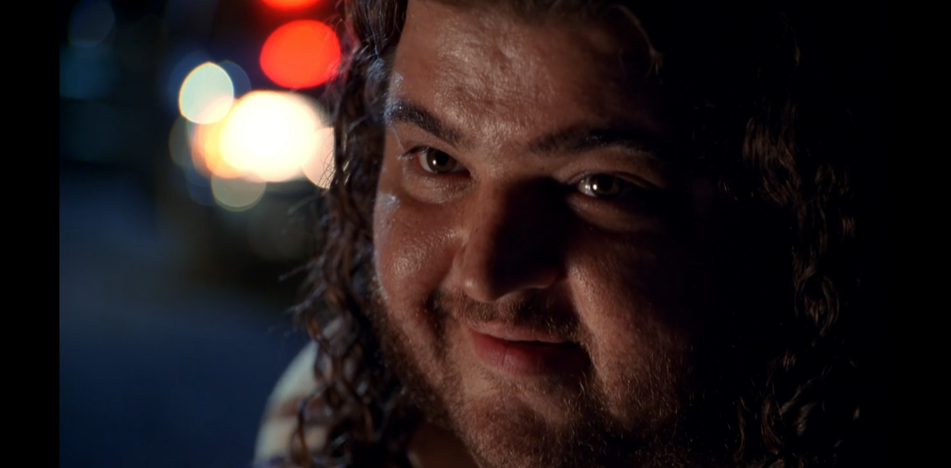 Hurley in tight close up smiles.
