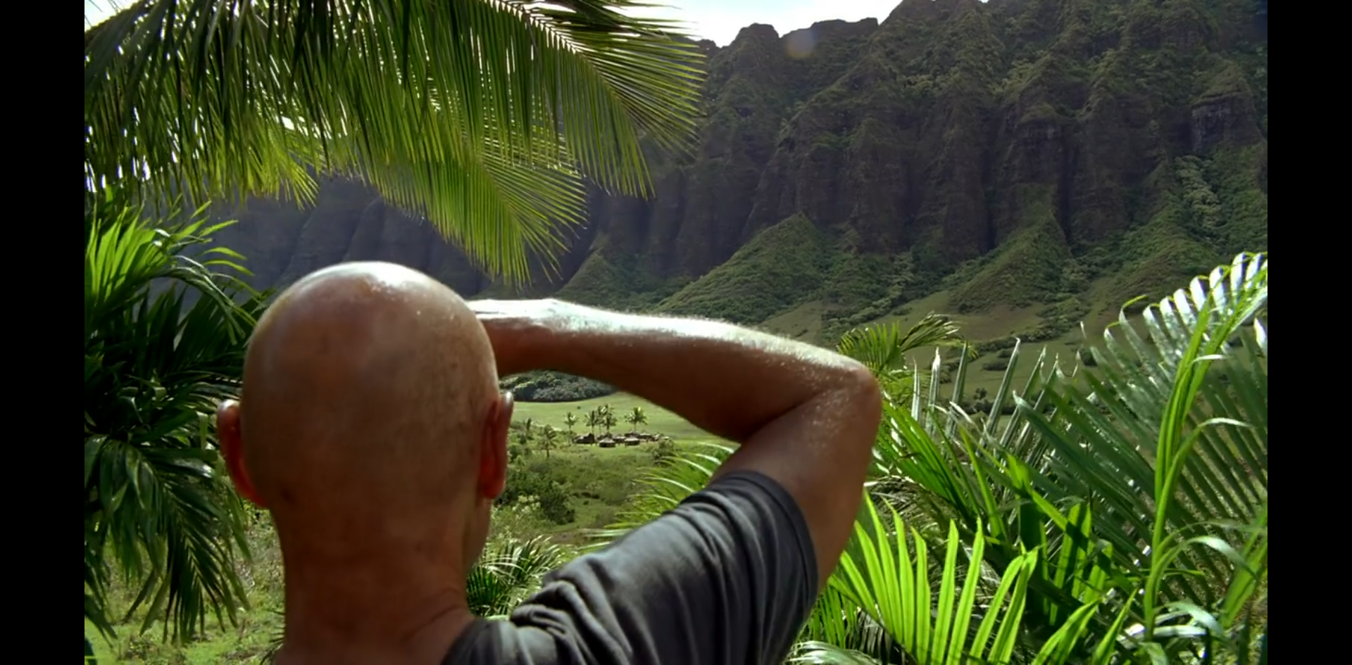 John Locke surveys the island valley with its military tents.