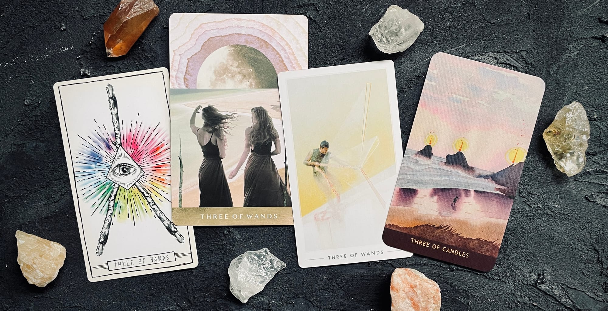 three of wands cards, from left to right: lumina tarot, moonchild tarot, fountain tarot, numinous tarot