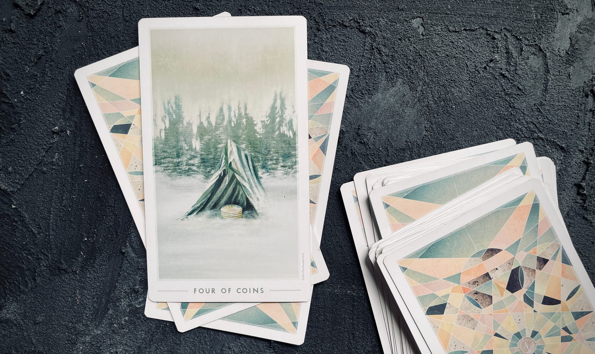 four of coins from the fountain tarot, an illustrated scene of a wintery field with trees in the background, a striped tent in the snow with coins stacked neatly inside