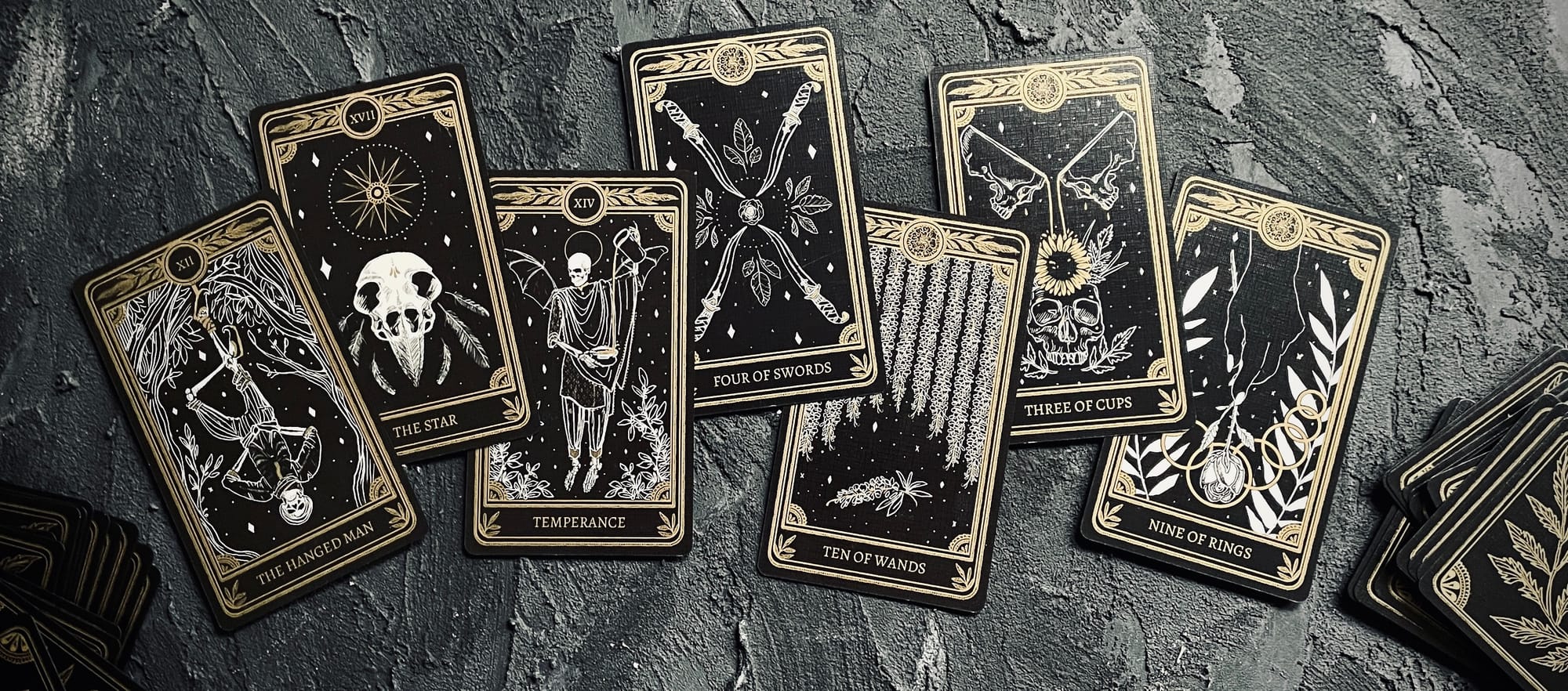 my rest menu in tarot, from left to right: hanged man, star, temperance, four of swords, ten of wands, three of cups, and nine of rings from the marigold tarot