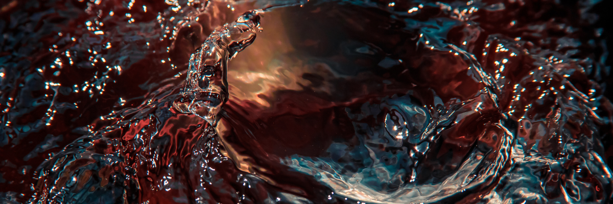 close up of water, with deep reds and blues and golds