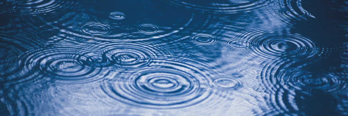 rain landing on the surface of water, ripples