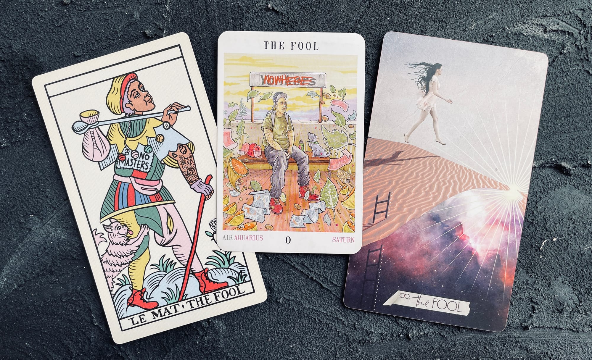 fool card from the gay marseille (left), next world tarot (center), and muse tarot (right)