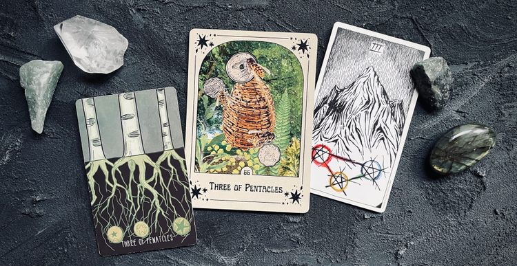 three of pentacles from three different tarot decks